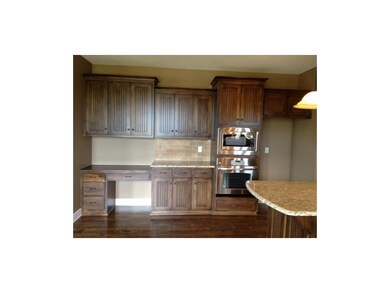 Planning desk area with custom birch cabinets.