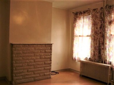 The large living room is off the main entry and the original mantel has been updated.