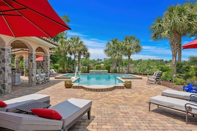 Community pool featuring a patio and an in-ground hot tub