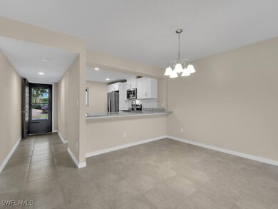 Kitchen with white cabinets, baseboards, stainless