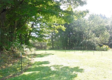 Deep lot is partially fenced for pets
