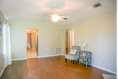 Sitting room with vaulted ceiling, ceiling fan, wo