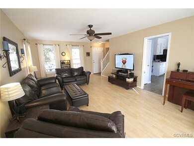 Family room is spacious, open and features laminat