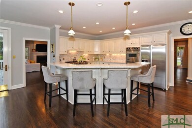 Kitchen with hardwood floors and new appliances.
