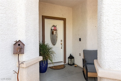 Doorway to property featuring stucco siding