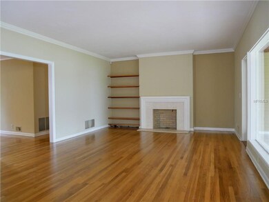 Large living room with natural oak floors and fireplace