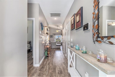 Hallway with wood finished floors and baseboards