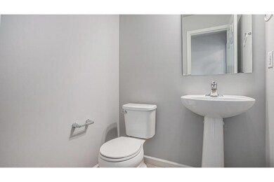 The first floor powder room is ideally located for