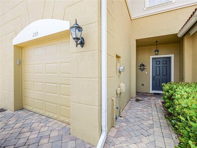 Doorway to property with a garage and stucco siding