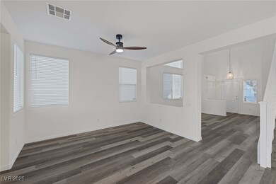 Empty room featuring ceiling fan, visible vents, b