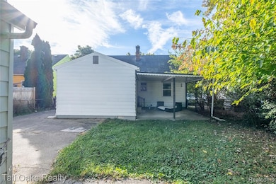 Back of property with a patio, a chimney, and roof with shingles