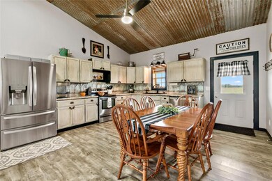 Kitchen featuring ceiling fan, appliances with sta