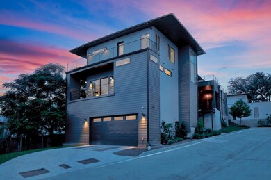 View of home's exterior with a balcony, a garage,