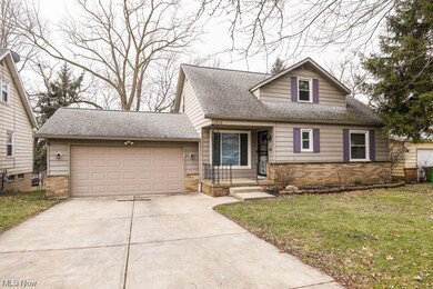 View of front of house with a front lawn and a garage