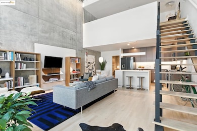 Living area with a towering ceiling and light wood finished floors