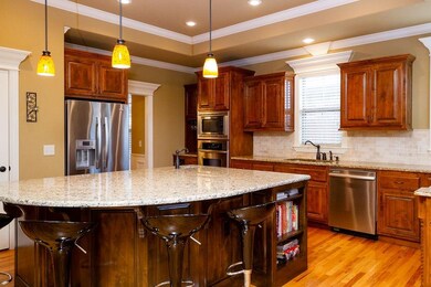 Oversize 3 centimeter granite inland with prep-sink, upgraded lighting, upgraded Stainless Steel appliances