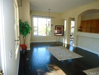 Rich wood flooring graces the living room and dini