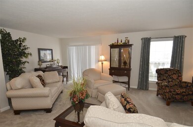 Living room has slider leading out to the deck