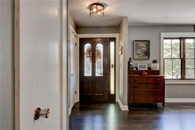 Entryway featuring baseboards and dark wood-style flooring