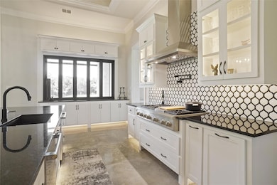Kitchen with stainless steel gas cooktop, wall chi
