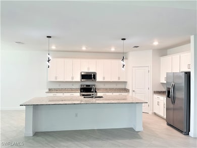 Kitchen with stainless steel appliances, a sink, a