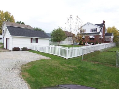 Vinyl picket fence, oversized one car garage and a
