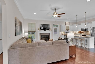 Living room featuring ornamental molding, dark woo