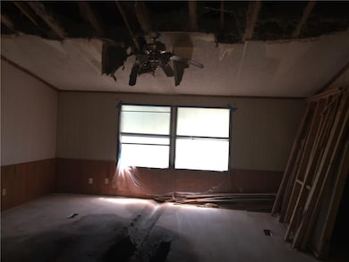 Living Room - Extensive ceiling damage and floor d