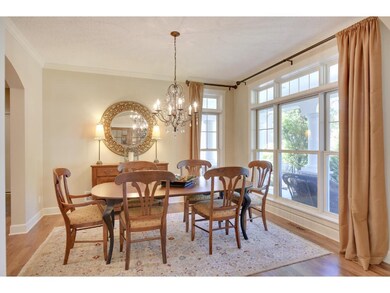 Gleaming hardwood floors flow from the foyer into 