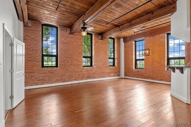 Empty room with wood ceiling, beamed ceiling, bric