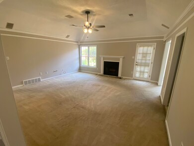 Unfurnished living room featuring visible vents, c
