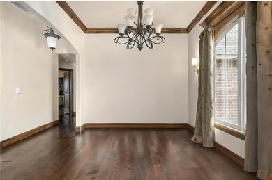 Unfurnished dining area with a chandelier, baseboa