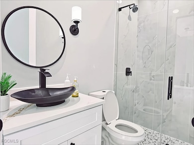 Full bath with a stall shower and vanity