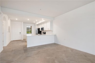 Kitchen with stainless steel appliances, white cab