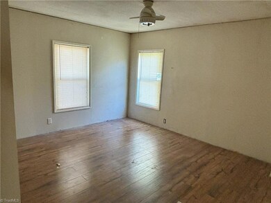 Primary bedroom with ceiling fan.