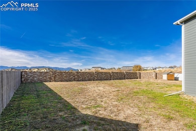 Fenced backyard featuring a mountain view