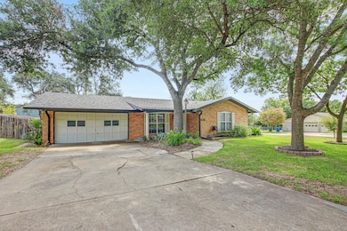 View of front of house with brick siding, a garag