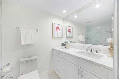 Full bath with vanity, a marble finish shower, light marble finish floors, and recessed lighting