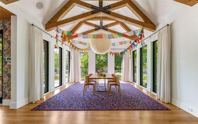 Sunroom / solarium with beamed ceiling and a healthy amount of sunlight