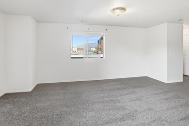 Carpeted empty room with baseboards