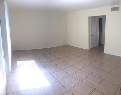Spacious living room with tile flooring
