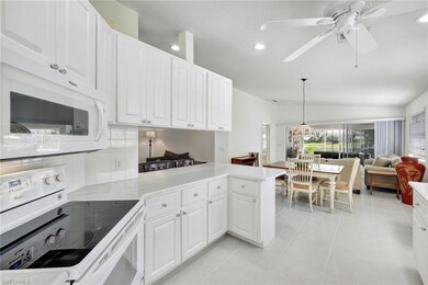 Kitchen with a peninsula, white appliances, white 