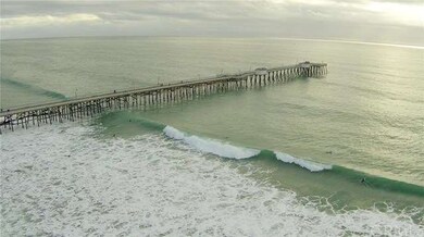 View of San Clemente Pier with surfers enjoying th