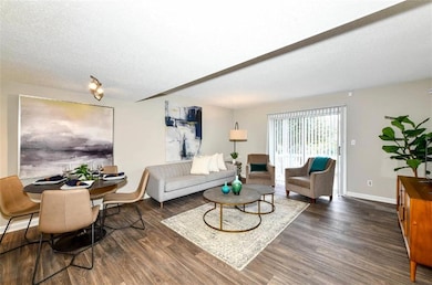 Living room with a textured ceiling and dark hardw