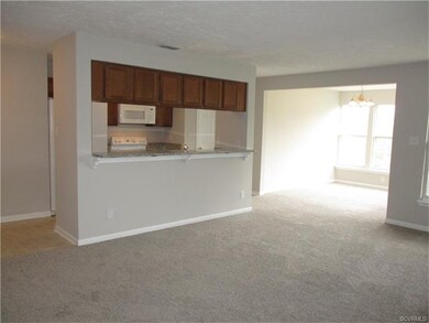 Galley Kitchen with view into dining room that has