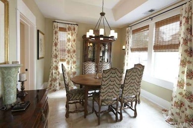 Bright and spacious formal dining room with traver