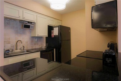 Kitchen with granite counters and tumbled marble b