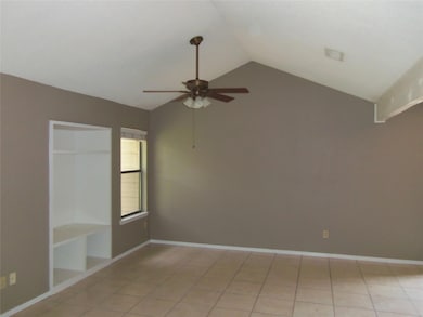 Empty room with ceiling fan, lofted ceiling, and 