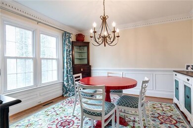 Alternate view of the formal dining room with chan