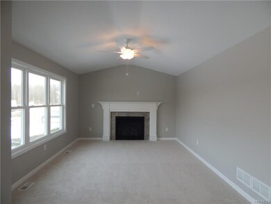 FAMILY ROOM WITH NUETRAL CARPET AND GAS FIREPLACE 